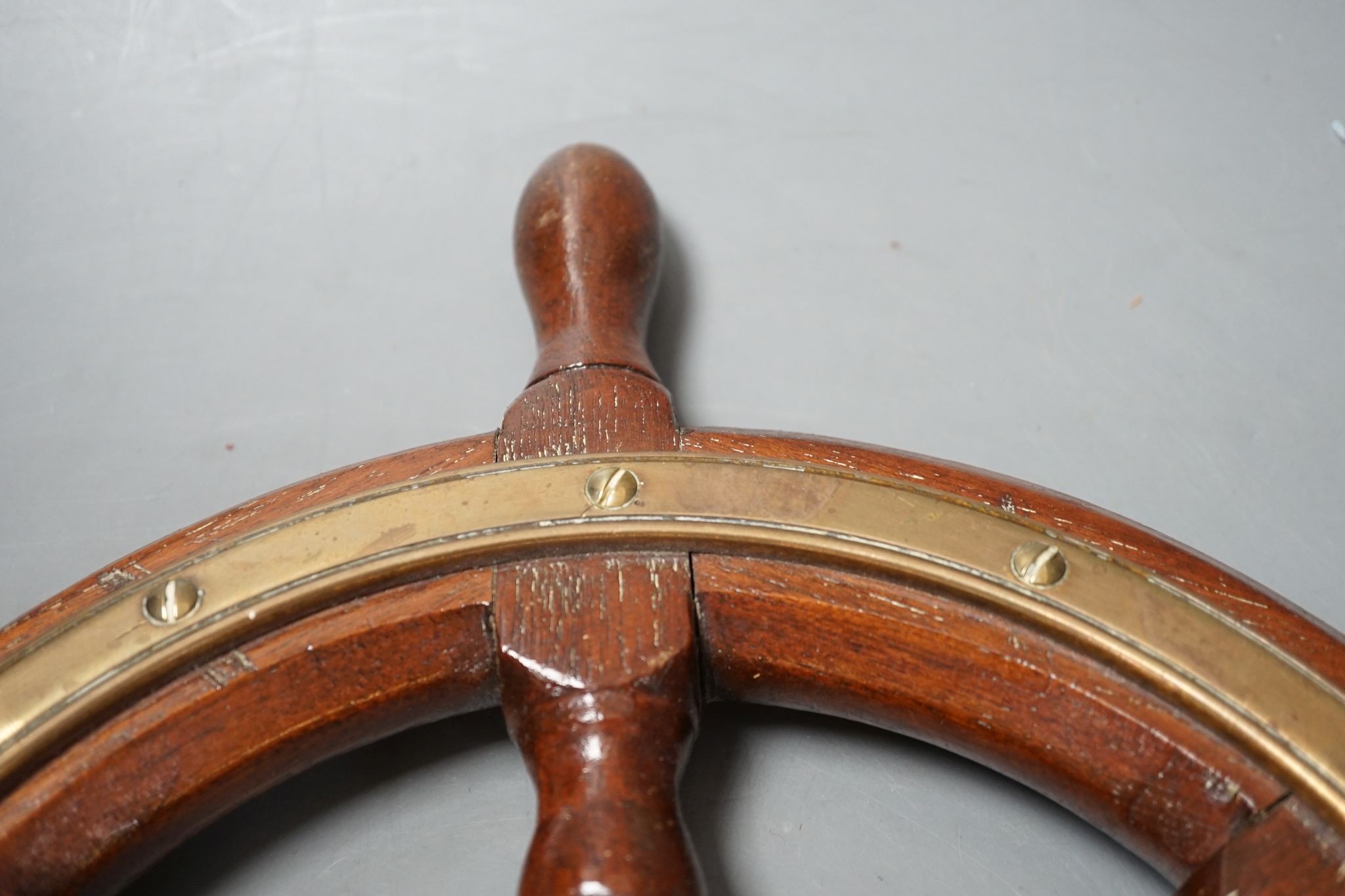 A teak and brass mounted Ship's wheel signed Lawrence Simpson 47cm